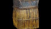 A tall square basket that tapers out slightly to bottom and curves under. 